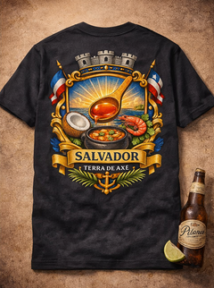 Black t-shirt with Salvadoran design featuring a spoon, flags, and traditional elements on a brown background.