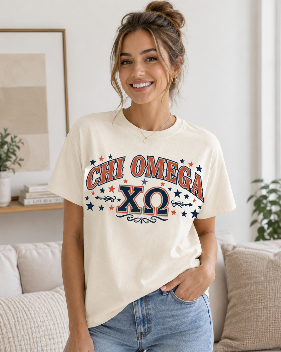 Woman wearing a cream Chi Omega T-shirt with red and navy collegiate lettering and Greek letters